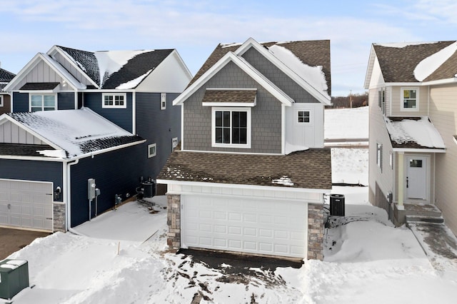 view of front of property featuring cooling unit and a garage