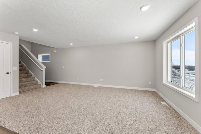 interior space featuring plenty of natural light and a textured ceiling