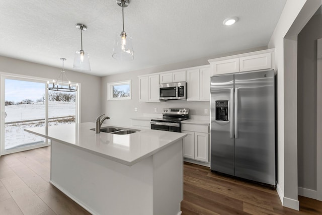 kitchen with white cabinets, pendant lighting, and appliances with stainless steel finishes