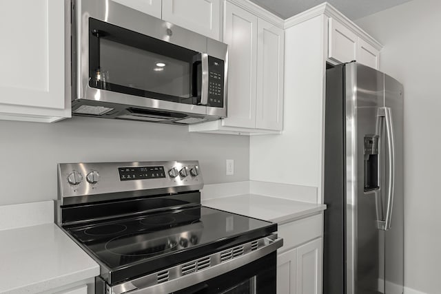 kitchen with white cabinets and appliances with stainless steel finishes