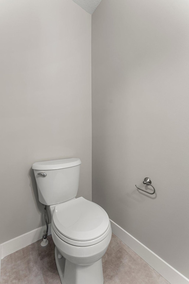 bathroom featuring a textured ceiling and toilet