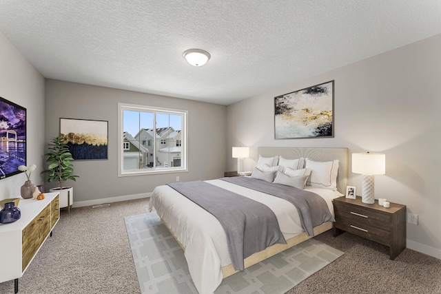 bedroom featuring light carpet and a textured ceiling