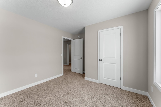 unfurnished bedroom with light colored carpet