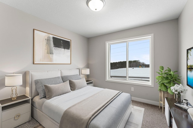 carpeted bedroom featuring a textured ceiling