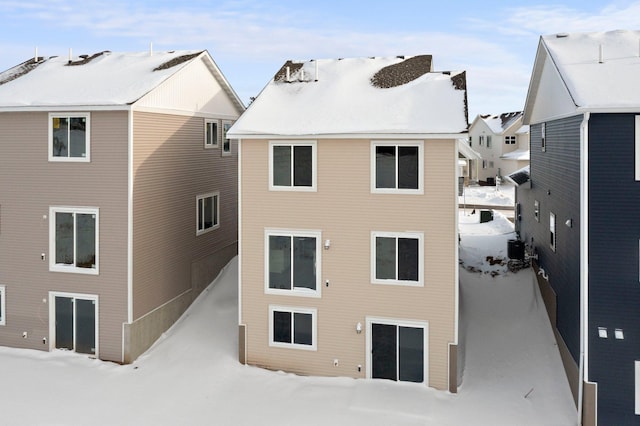 view of snow covered rear of property