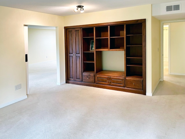 unfurnished living room featuring light colored carpet