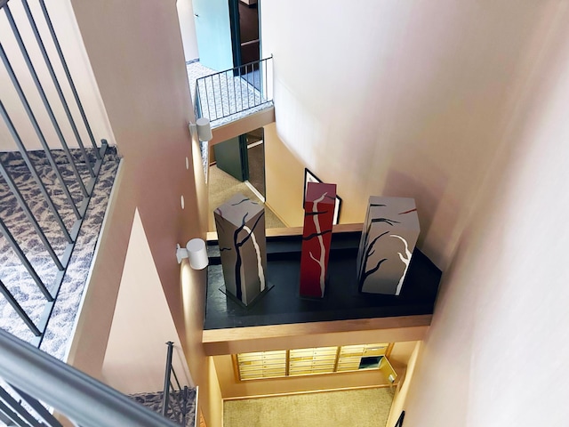 stairs with carpet and a high ceiling