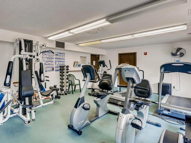 exercise room with a textured ceiling