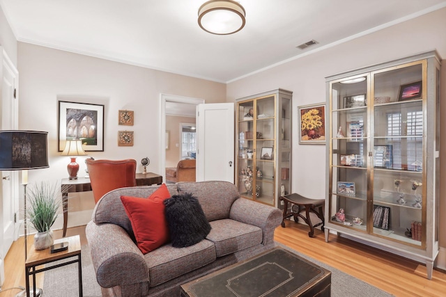 living room featuring ornamental molding and hardwood / wood-style floors