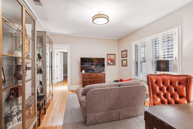 living room with french doors, ornamental molding, and hardwood / wood-style floors