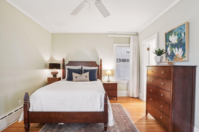 bedroom featuring light hardwood / wood-style flooring, a baseboard heating unit, ceiling fan, and ornamental molding