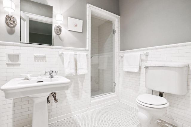 bathroom with tile walls, walk in shower, tile patterned floors, and toilet