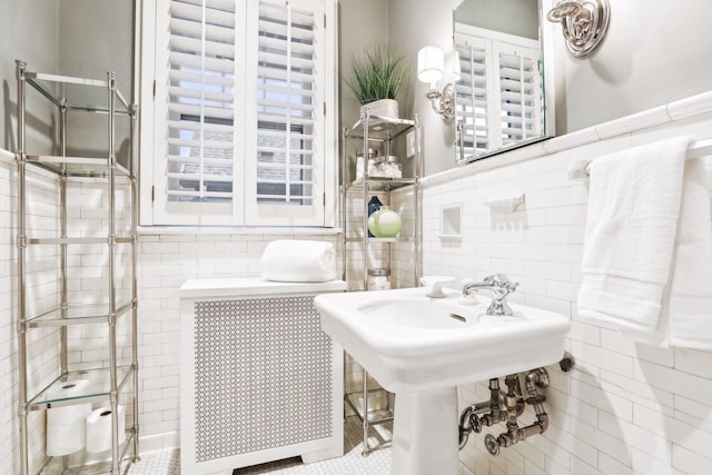 bathroom with tile walls and tile patterned flooring