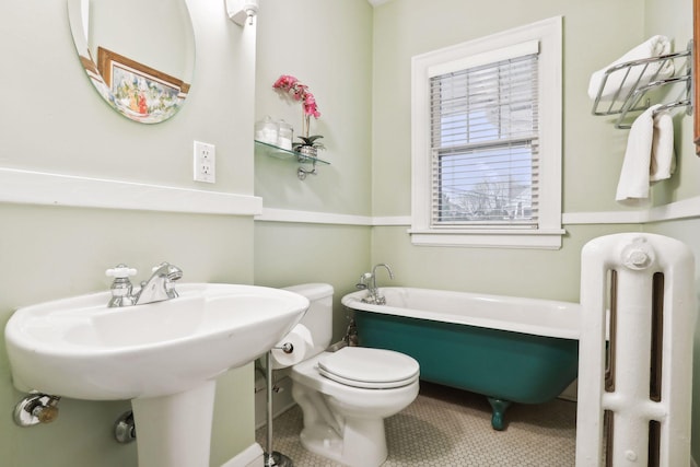 bathroom featuring tile patterned flooring, a washtub, sink, radiator, and toilet