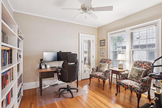 office area with ornamental molding, ceiling fan, a baseboard radiator, and hardwood / wood-style flooring