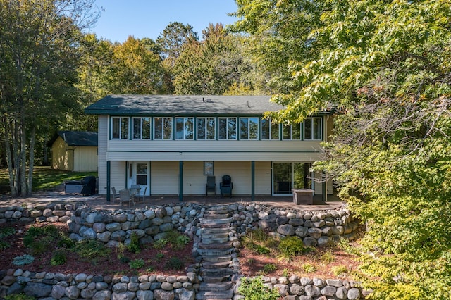 27734 Ridgewood Dr, Merrifield, MN 56465 - back of house featuring a patio area, an outbuilding, a shed, and a sunroom