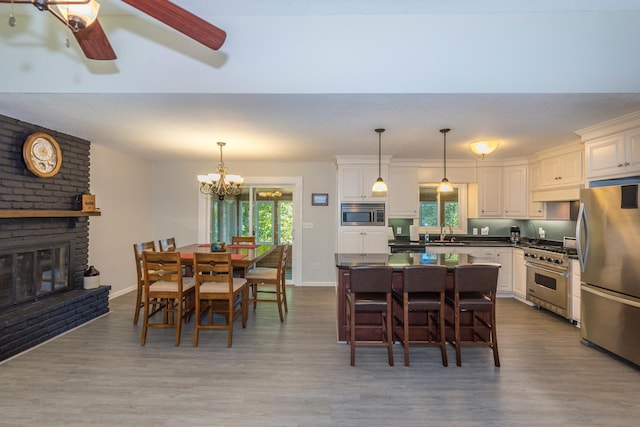 27734 Ridgewood Dr, Merrifield, MN 56465 - dining area with ceiling fan with notable chandelier, baseboards, and wood finished floors