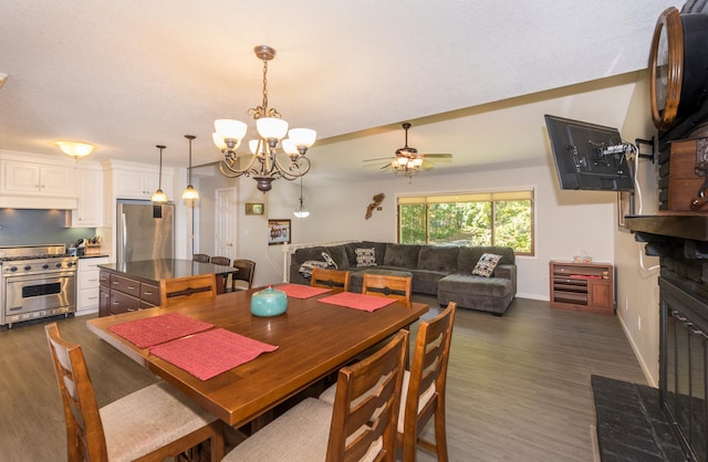 27734 Ridgewood Dr, Merrifield, MN 56465 - dining room featuring dark wood-style flooring, ceiling fan with notable chandelier, and baseboards