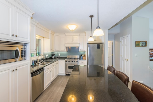 27734 Ridgewood Dr, Merrifield, MN 56465 - kitchen featuring hanging light fixtures, light wood-style flooring, a sink, appliances with stainless steel finishes, and custom range hood