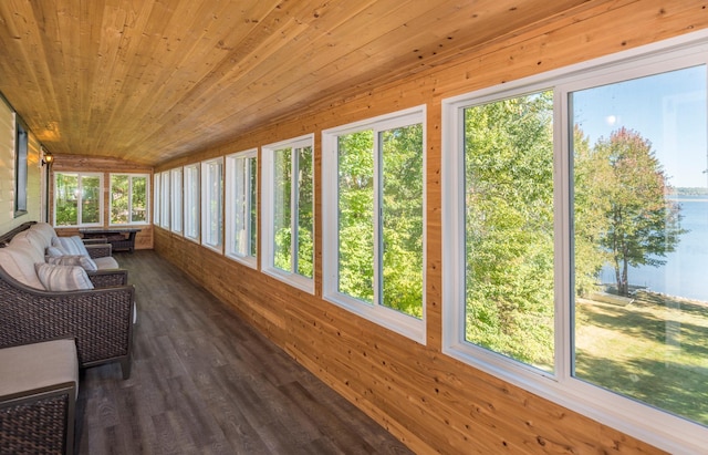 sunroom with wooden ceiling, a healthy amount of sunlight, and a water view