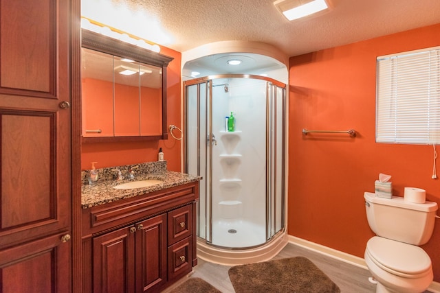 27734 Ridgewood Dr, Merrifield, MN 56465 - bathroom with toilet, a stall shower, a textured ceiling, baseboards, and vanity