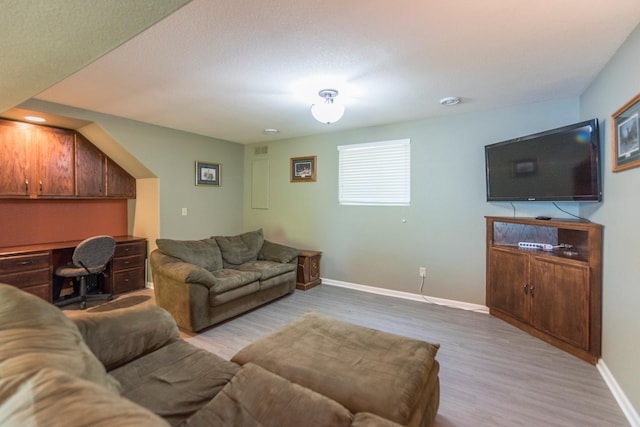 living room featuring light hardwood / wood-style floors and a textured ceiling