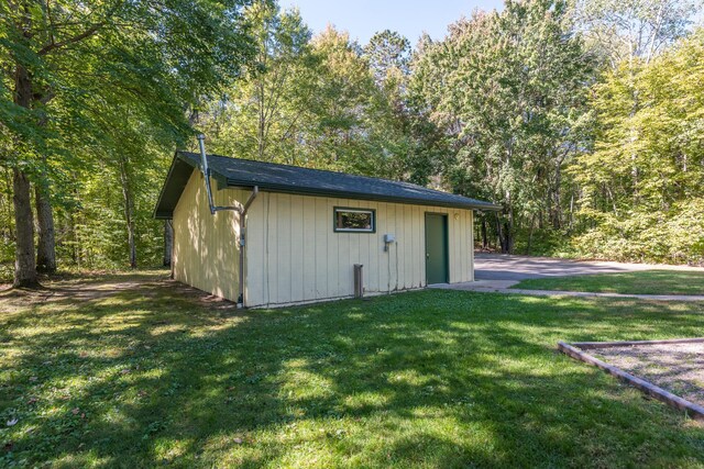 view of outbuilding with a yard