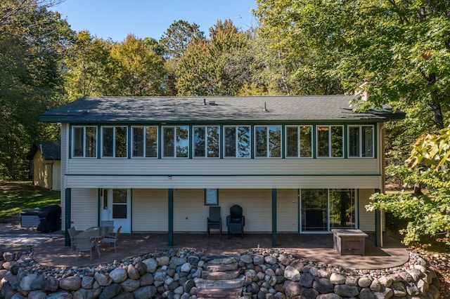 27734 Ridgewood Dr, Merrifield, MN 56465 - rear view of property with a patio, a sunroom, and a shingled roof
