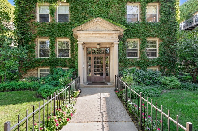 entrance to property with a lawn