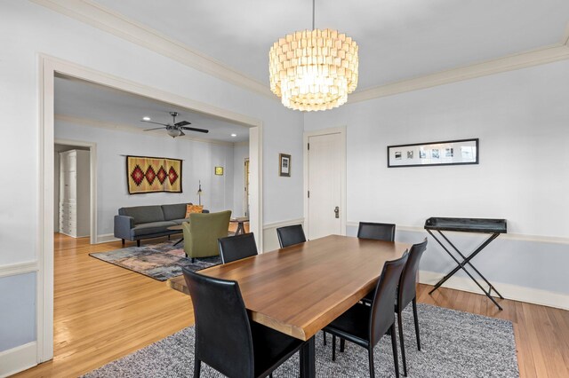 dining room with ceiling fan with notable chandelier, crown molding, and light hardwood / wood-style floors