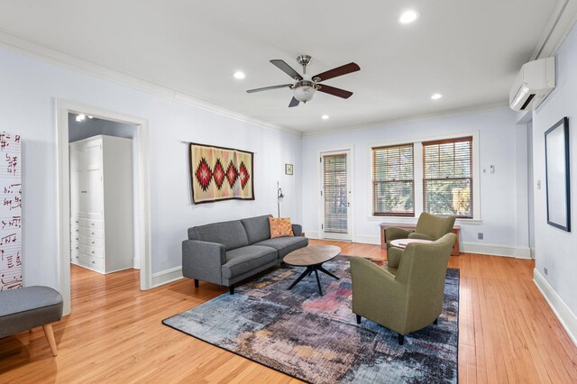 living room featuring an AC wall unit, ceiling fan, light hardwood / wood-style flooring, and crown molding