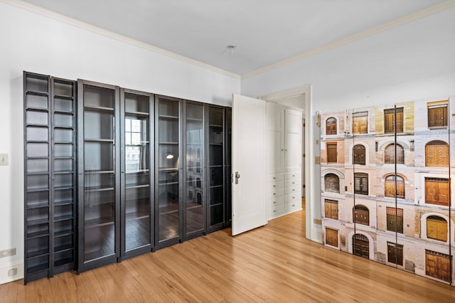 interior space with hardwood / wood-style flooring and crown molding