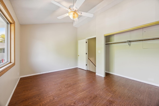 unfurnished bedroom with a closet, vaulted ceiling, dark hardwood / wood-style flooring, and ceiling fan