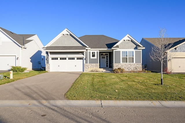 craftsman inspired home featuring a front yard and a garage