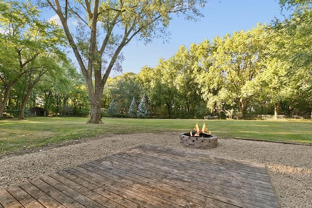 view of patio with an outdoor fire pit and a deck