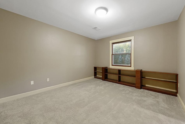 spare room featuring light colored carpet