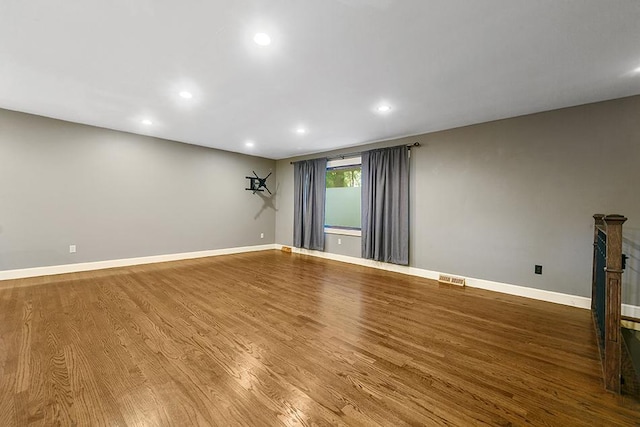 spare room featuring wood-type flooring