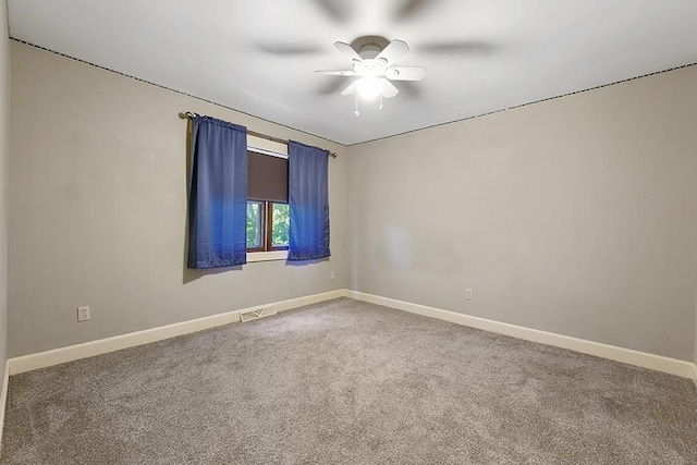 carpeted spare room featuring ceiling fan