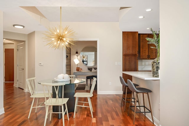 dining room featuring an inviting chandelier and dark hardwood / wood-style floors