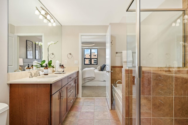 bathroom featuring tile walls, walk in shower, tile patterned floors, vanity, and toilet