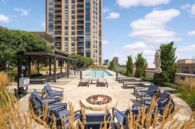 view of pool with a patio and an outdoor fire pit