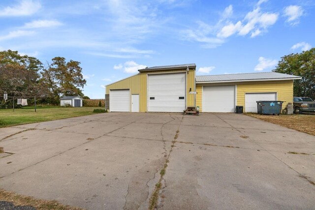 view of home's exterior with an outbuilding, a yard, and a garage