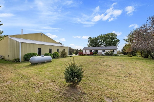 view of yard with an outbuilding, a pole building, and a detached garage