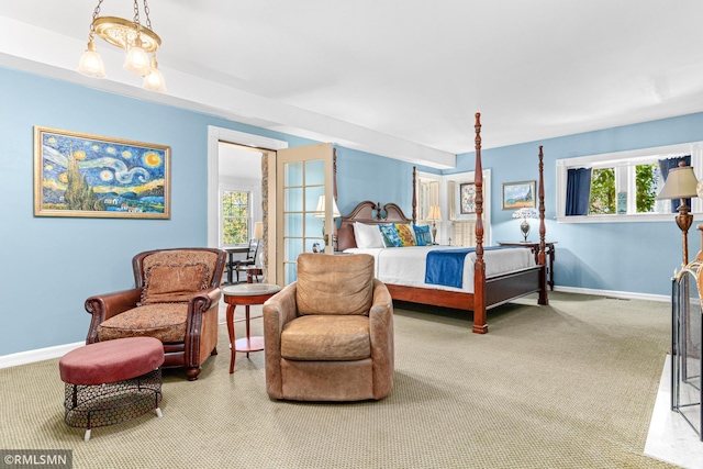 bedroom featuring multiple windows and carpet