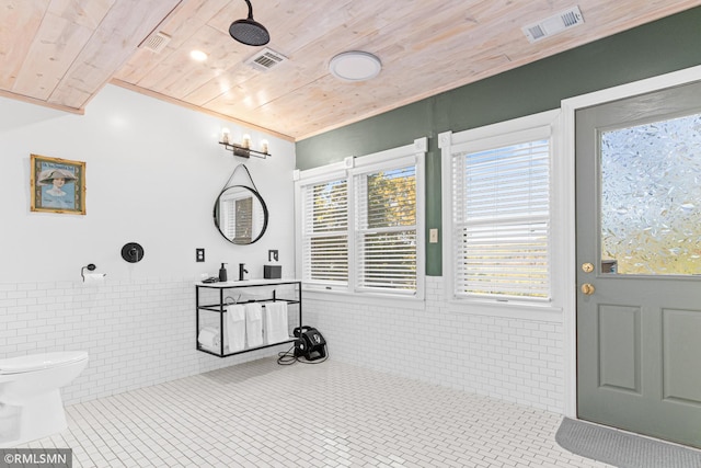 bathroom with vanity, tile patterned flooring, wooden ceiling, tile walls, and toilet