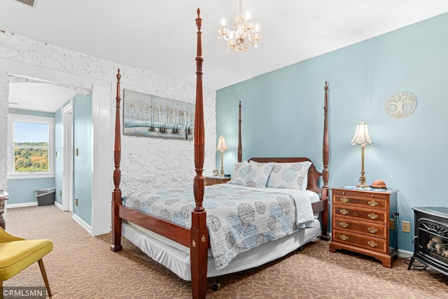 carpeted bedroom featuring an inviting chandelier