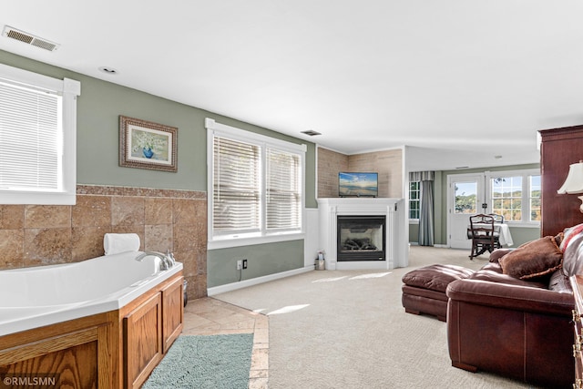 living room featuring tile walls and light colored carpet