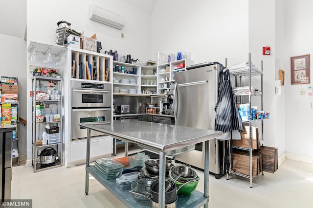 kitchen with light carpet, stainless steel appliances, and a wall mounted AC