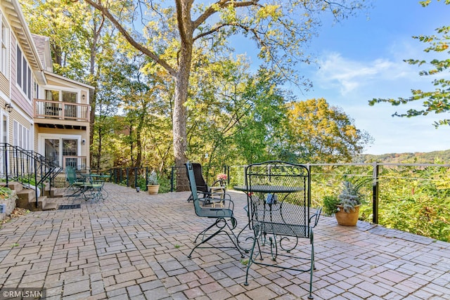 view of patio featuring a balcony