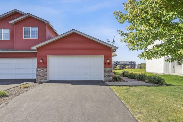 view of front facade with a front yard and a garage